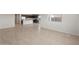 Open-concept living area with tiled floors and connection to the kitchen at 17845 W Getty Dr, Goodyear, AZ 85338