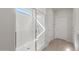 Modern bathroom shower featuring tiled walls, glass door, and natural light from a window at 17845 W Getty Dr, Goodyear, AZ 85338