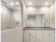 Spacious bathroom featuring double sink vanity with shower behind a glass wall at 17851 W Getty Dr, Goodyear, AZ 85338