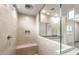 Clean and contemporary bathroom with tiled shower, shower bench, and glass enclosure at 17851 W Getty Dr, Goodyear, AZ 85338