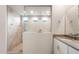 Modern bathroom with a tiled shower and white vanity with quartz countertop at 17851 W Getty Dr, Goodyear, AZ 85338