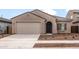 Charming single-story home featuring a two-car garage and low maintenance desert landscaping at 17851 W Getty Dr, Goodyear, AZ 85338