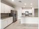 Well-lit kitchen with stainless steel appliances, gray backsplash, and modern finishes at 17851 W Getty Dr, Goodyear, AZ 85338