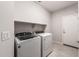 Neat laundry room with tile floors, shelving, and new appliances at 17851 W Getty Dr, Goodyear, AZ 85338