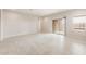 Open living area featuring tiled floors, neutral paint, and plenty of natural light at 17851 W Getty Dr, Goodyear, AZ 85338