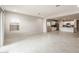 Bright, open floor plan with tile flooring, white walls and an open flow to the kitchen at 17851 W Getty Dr, Goodyear, AZ 85338