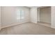 Bright living room featuring neutral walls, plush carpet, and large window at 17851 W Getty Dr, Goodyear, AZ 85338