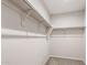 Spacious walk-in closet with open shelving and neutral carpet at 17851 W Getty Dr, Goodyear, AZ 85338