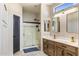 Modern bathroom with double vanity, patterned walls and glass shower at 18420 N 20Th Pl, Phoenix, AZ 85022