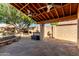 Luxurious back patio features ceiling fans, stone flooring, built-in grill, and tranquil pool at 18525 N 85Th N Ave, Peoria, AZ 85382