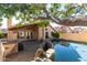 The pristine pool, covered patio, and lush landscaping create a relaxing backyard oasis at 18525 N 85Th N Ave, Peoria, AZ 85382