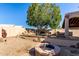 Backyard boasts a built in fire pit, stone pool, built in grill, and is shaded by a large mature tree at 18525 N 85Th N Ave, Peoria, AZ 85382
