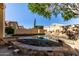A backyard pool features rock accents and a raised spa, offering a private outdoor oasis at 18525 N 85Th N Ave, Peoria, AZ 85382