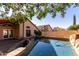 Relaxing backyard pool with stone accents, beautiful landscaping, and covered patio; ideal for outdoor living at 18525 N 85Th N Ave, Peoria, AZ 85382