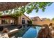 Relaxing backyard pool with stone accents, beautiful landscaping, and covered patio; ideal for outdoor living at 18525 N 85Th N Ave, Peoria, AZ 85382