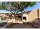 Outdoor fire place in the backyard makes for cozy nights, right by the serene pool and mature shade tree at 18525 N 85Th N Ave, Peoria, AZ 85382