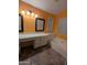 Well-lit bathroom featuring a tub, vanity, and earth-toned tile flooring at 18525 N 85Th N Ave, Peoria, AZ 85382