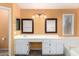 Bathroom with a white vanity, dual mirrors, and a window allowing for natural light at 18525 N 85Th N Ave, Peoria, AZ 85382