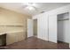 Bedroom featuring wood floors, ceiling fan, built-in desk and closet with sliding doors at 18525 N 85Th N Ave, Peoria, AZ 85382