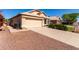 Charming single-story home with a two-car garage, desert landscaping, and a tile roof at 18525 N 85Th N Ave, Peoria, AZ 85382