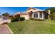 Charming single-story home with a two-car garage, desert landscaping, and a tile roof at 18525 N 85Th N Ave, Peoria, AZ 85382