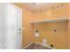 Functional laundry room with white shelving unit and decorative wallpaper border adds a touch of charm at 18525 N 85Th N Ave, Peoria, AZ 85382