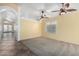 A bright living room with tile and carpet flooring, neutral walls, and a ceiling fan at 18525 N 85Th N Ave, Peoria, AZ 85382