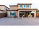 A large, neutral gravel backyard with covered patio provides a tranquil setting at 19703 W Badgett Ln, Litchfield Park, AZ 85340