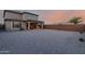 Spacious backyard featuring low-maintenance gravel landscaping, covered patio and beautiful sunset views at 19703 W Badgett Ln, Litchfield Park, AZ 85340