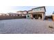 Spacious backyard featuring neutral gravel, patio, and access to the home at 19703 W Badgett Ln, Litchfield Park, AZ 85340
