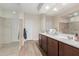 Well-lit bathroom with dual sinks, a walk-in shower, and modern finishes at 19703 W Badgett Ln, Litchfield Park, AZ 85340