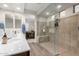 Modern bathroom featuring a glass-enclosed shower, dual sinks, and stylish fixtures at 19703 W Badgett Ln, Litchfield Park, AZ 85340