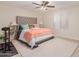 Bright bedroom features plush carpet, neutral walls, and a comfortable bed with decorative pillows at 19703 W Badgett Ln, Litchfield Park, AZ 85340