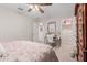 Bright bedroom features neutral walls and carpet, a desk and artwork at 19703 W Badgett Ln, Litchfield Park, AZ 85340