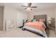 A beautiful bedroom featuring a large bed and a ceiling fan at 19703 W Badgett Ln, Litchfield Park, AZ 85340