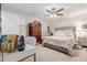 Cozy bedroom with plush bedding, neutral walls, and a ceiling fan at 19703 W Badgett Ln, Litchfield Park, AZ 85340