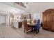 Charming dining area with wooden table, decorative armoire, and view of kitchen at 19703 W Badgett Ln, Litchfield Park, AZ 85340