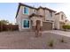 Two-story home with neutral stucco, two-car garage and desert landscaping at 19703 W Badgett Ln, Litchfield Park, AZ 85340