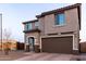 Two-story home with neutral stucco, two-car garage and desert landscaping at 19703 W Badgett Ln, Litchfield Park, AZ 85340