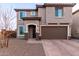 Charming two-story home featuring a neutral stucco exterior, two-car garage and welcoming front entry at 19703 W Badgett Ln, Litchfield Park, AZ 85340