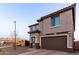 Two-story home with neutral stucco, two-car garage and desert landscaping at 19703 W Badgett Ln, Litchfield Park, AZ 85340