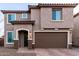 Charming two-story home featuring a neutral stucco exterior, two-car garage and welcoming front entry at 19703 W Badgett Ln, Litchfield Park, AZ 85340