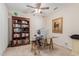 Bright home office with built-in bookshelves, large desk, and plenty of storage at 19703 W Badgett Ln, Litchfield Park, AZ 85340