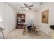 Bright home office with built-in bookshelves, large desk, and plenty of storage at 19703 W Badgett Ln, Litchfield Park, AZ 85340