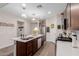 Well-equipped kitchen featuring an island with a sink and seating, stainless appliances, and plenty of counter space at 19703 W Badgett Ln, Litchfield Park, AZ 85340