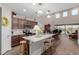 Inviting kitchen open to a living area, featuring an island, stainless steel appliances, and open floor plan at 19703 W Badgett Ln, Litchfield Park, AZ 85340