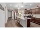Beautiful kitchen with an island, stainless steel appliances, pendant lighting and modern finishes at 19703 W Badgett Ln, Litchfield Park, AZ 85340