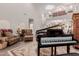 Open living room with piano, tall ceilings, staircase and elegant furnishings at 19703 W Badgett Ln, Litchfield Park, AZ 85340