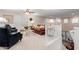 Bright and airy living room features a comfortable seating arrangement and staircase at 19703 W Badgett Ln, Litchfield Park, AZ 85340