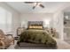 Bright main bedroom featuring a comfortable bed, ceiling fan, and ample natural light at 19703 W Badgett Ln, Litchfield Park, AZ 85340